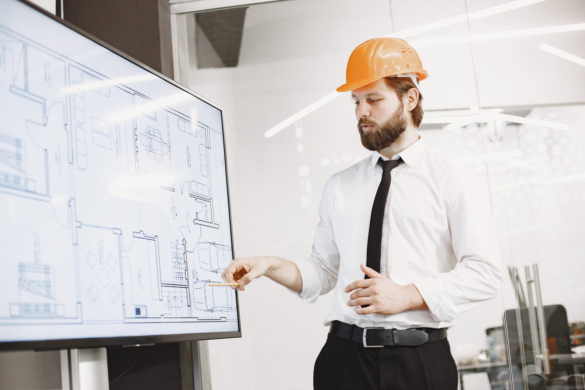 Construction Worker Explaining Blueprints